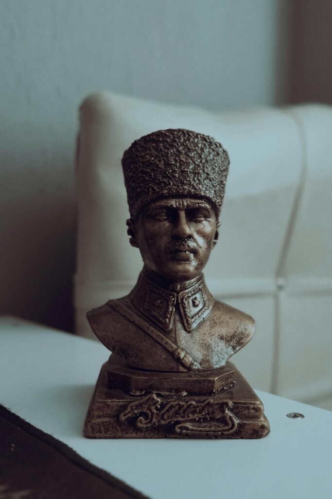 Bronze bust of Atatürk placed indoors with soft lighting creating a classic aesthetic.